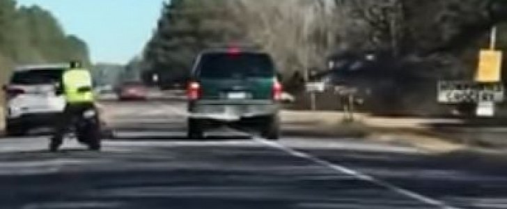 Car tows biker and bike with a tow strap, hilarity ensues