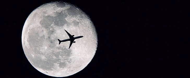 Airplane passing in front of the Moon
