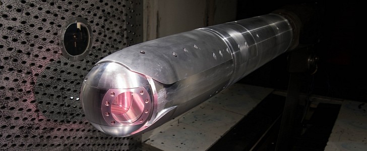 A directed energy (DE) system turret positioned on a sting in the wind tunnel