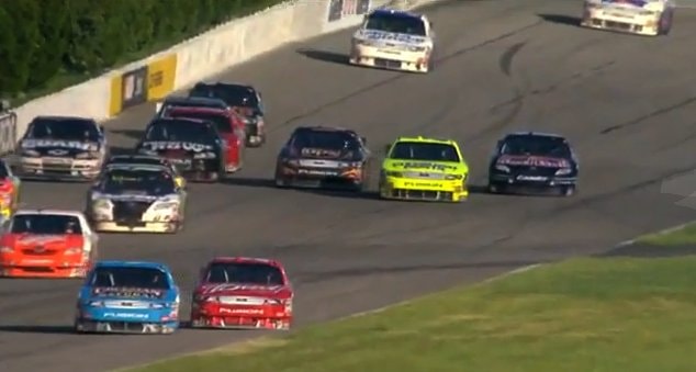 Allmendinger (blue Fusion) pushes Kahne (red Fusion) into the grass
