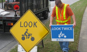 Allstate Sign Installations Warn Drivers to Look Out for Riders
