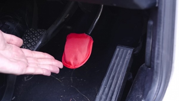A brake pedal covered in a red cover for a YouTube challenge