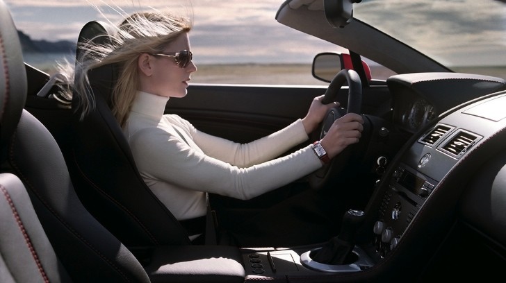 woman driving Aston Martin V8 Vantage Roadster