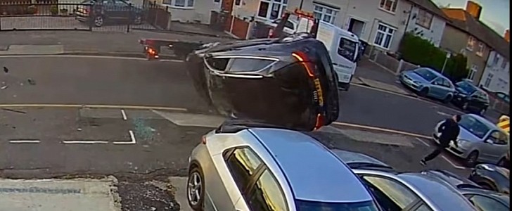 Audi Driver Crashes into Flatbed Truck, Flips Over Twice