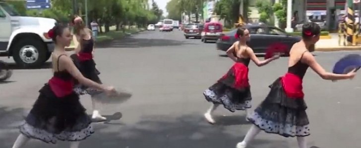 Ballet dancers entertain drivers and pedestrians in Mexico City, during traffic stops