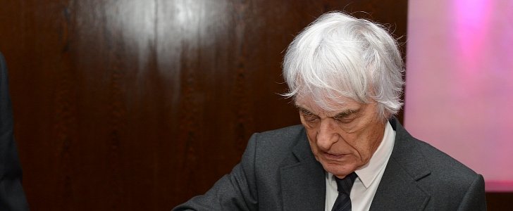 Bernie Ecclestone signing his picture at the Zoom Charity Auction