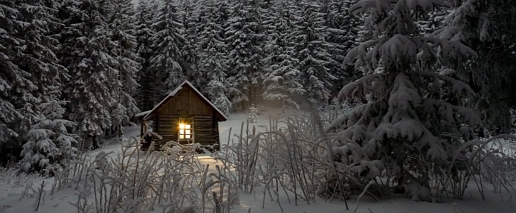 Wooden house in forest during winter time