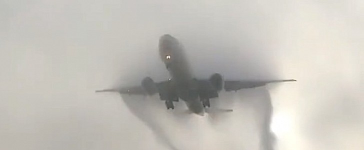Boeing 777 emerging from clouds