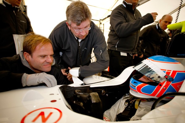 Ross Brawn and Rubens Barrichello take notes from Jenson Button, who has just completed his maiden test on the BGP 001