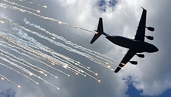 C-17 Globemaster III shooting flares over Bollen Range