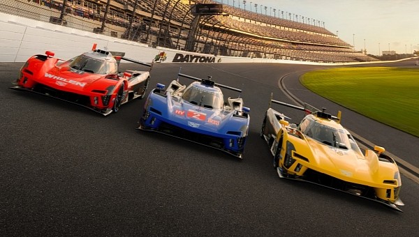Cadillac V-LMDh race cars wearing their blue, red and gold liveries at Daytona International Speedway. Simulated vehicles shown.