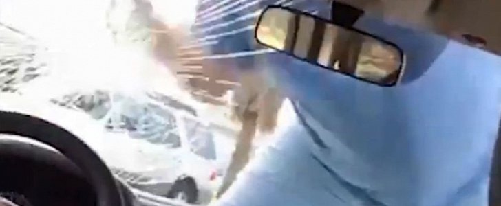 Man jumps on the hood of woman's car, smashes her windshield with his fist
