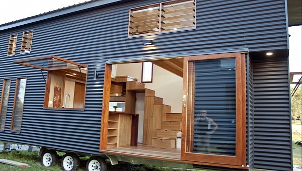 This bespoke tiny home with two loft bedrooms boasts stunning woodwork