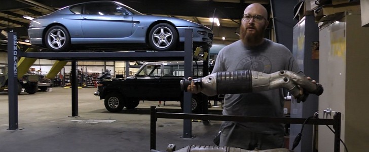 Car Wizard Holding a Catalytic Converter