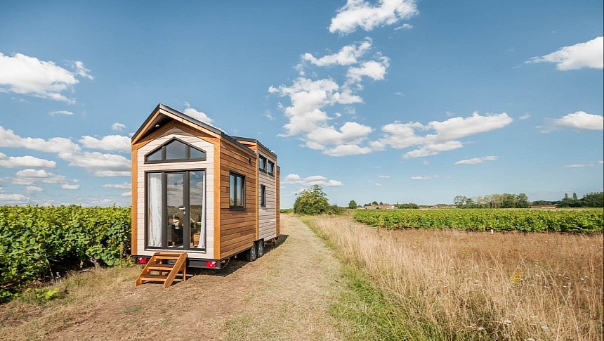 This tiny house reveals a beautiful glass facade with a main entrance