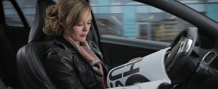 Woman reading in a self-driving Volvo