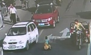 Chinese Toddler Rides Toy Bike Against Traffic, Doesn't Get Hurt