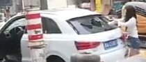 Woman Methodically Smashes Audi Q3 with a Rock in China