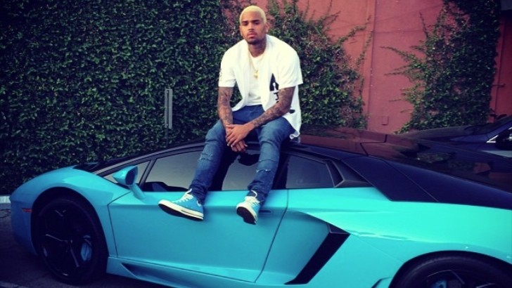 Chris Brown sits on his Aventador