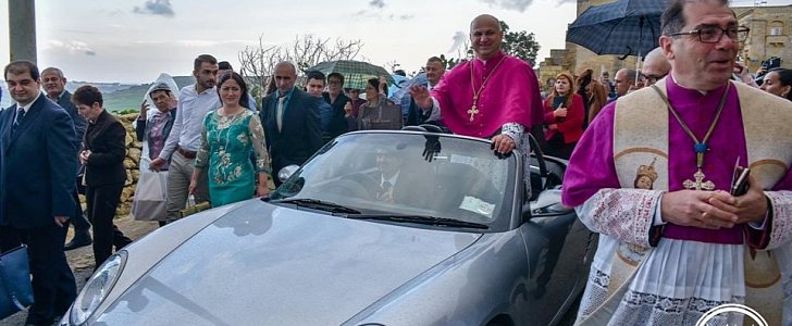 Priest arrives in city in Malta in a convertible Porsche Boxster, is pulled around town by 50 children