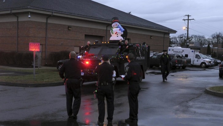 Police Officers Use Armored Military Vehicle to Deliver Toys to Needy Childrent