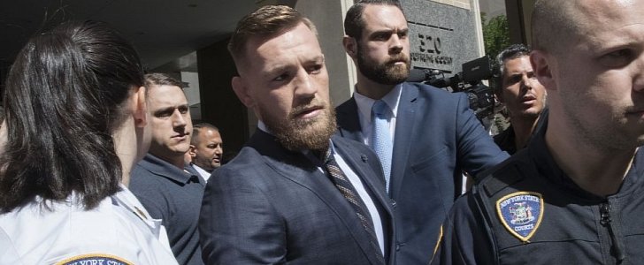 Conor McGregor is surrounded by cops and reporters after his big court date, following bus attack