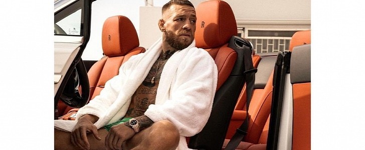 Former UFC double-champion Conor McGregor poses in his white Rolls-Royce Phantom Dawn
