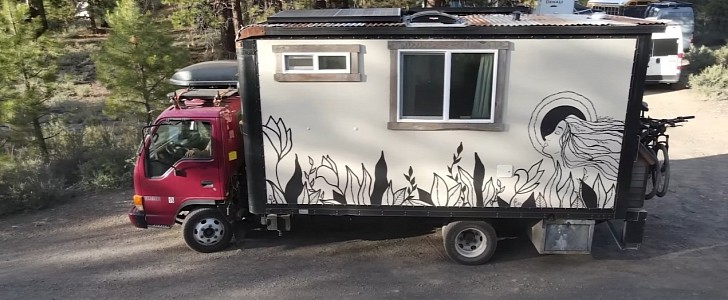 This Isuzu NPR became a cozy home on wheels for a couple and their furry friend