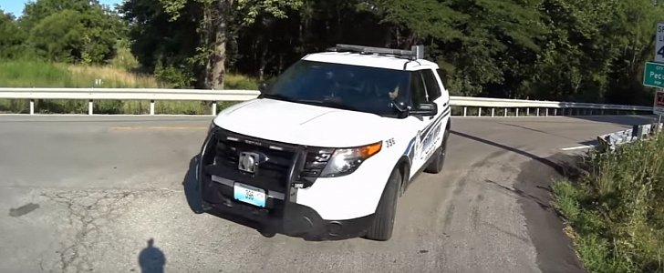 Police cruiser hits bike rider, as driver is distracted by his phone at an intersection