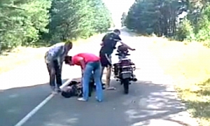 Drunk Russian Rider Sleeping near His Bike in the Middle of the Road