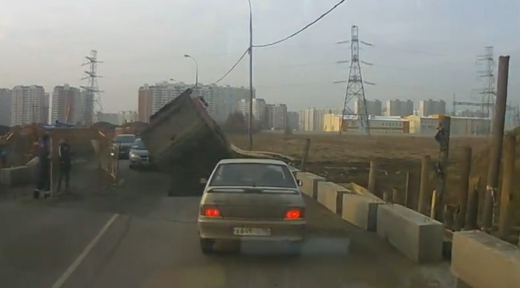 Dump Truck Collapses Through Bad Russian Road, Smashes a Car