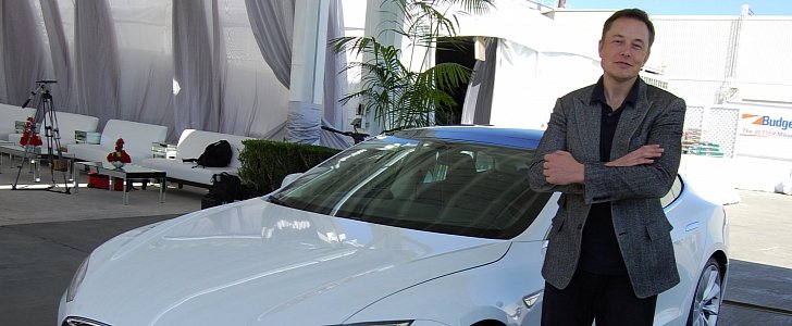 Elon Musk in front of a Tesla Model S