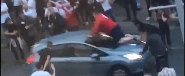 England fans climbs on top of moving car to celebrate World Cup victory