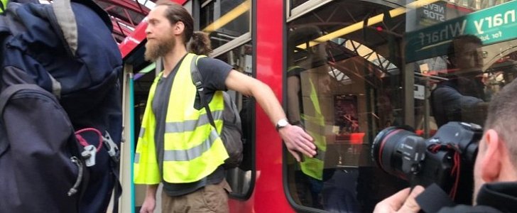 Extinction Rebellion member glued to DLR train in London