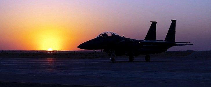 Sun setting over an F-15E Strike Eagle