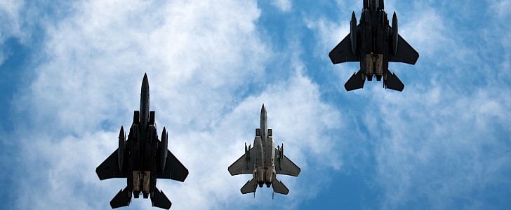 Three F-15s fly missing man formation over Britain air base