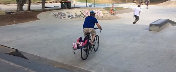 Biker in viral video comes under fire for poor parenting after his daughter's neck snaps during ride