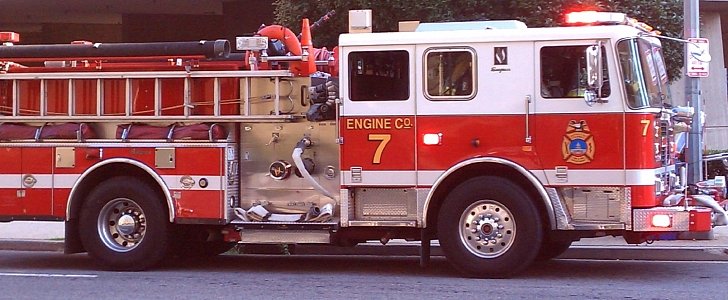  Left side view of the cab and part of the body of a District of Columbia Fire and Emergency Medical Services Department fire ladder truck