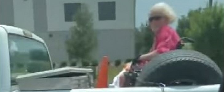 Woman in wheelchair travels in style, in the back of a pickup truck