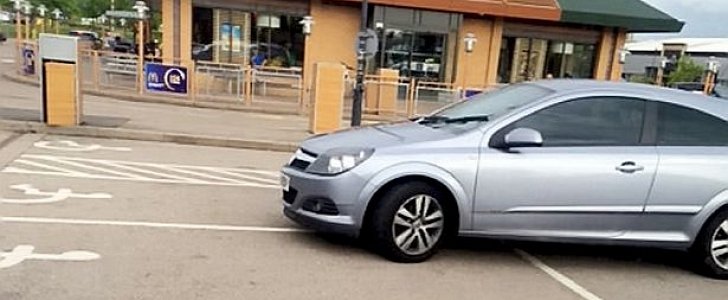 Opel Astra parked on four disabled spaces 