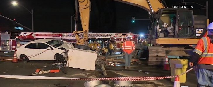 Toyota Corolla crashes into construction equipment, throws worker down 20-foot open manhole