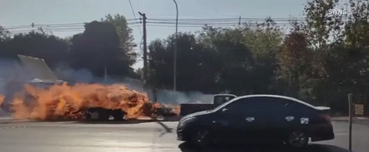 Pickup with trailer on fire shown speeding on Thai town street 