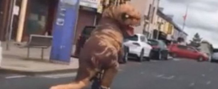 Giant dinosaur rides tiny bike down busy street in Northern Ireland
