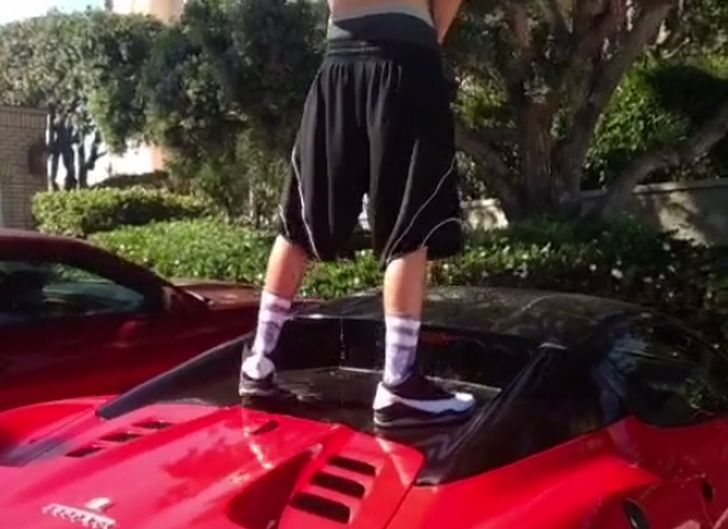 Guy pissing on Ferrari 458 Spider roof