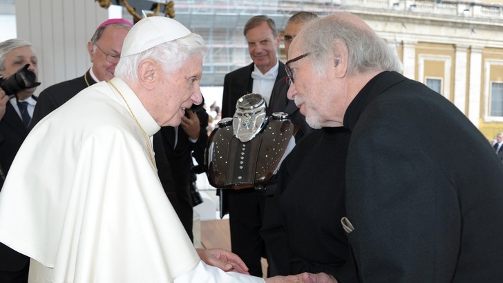 Pope Benedict blesses and signs two commemorative Harley Davidson tanks.
