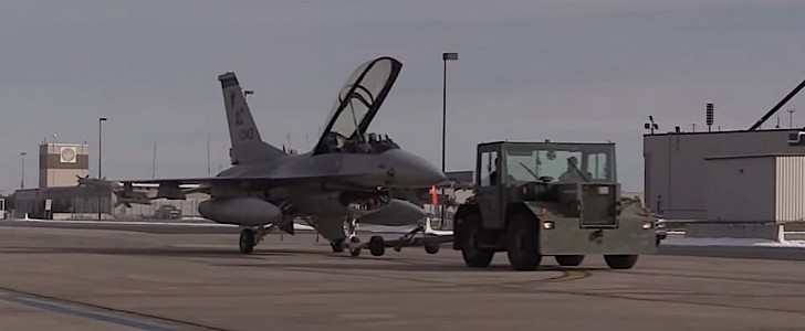 F-16 Fighting Falcon being towed to hangar
