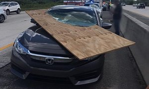 Honda Driver Uninjured After Windshield is Impaled by Huge Piece of Plywood