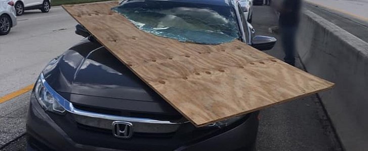 Honda windshield impaled by flying piece of plywood, driver walks away unharmed