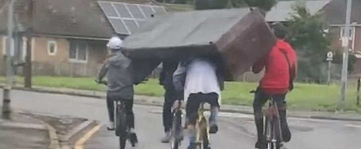 4 teens move a couch on their bikes, using only their shoulders and heads