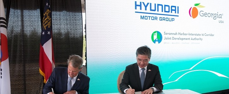 Governor Brian P. Kemp and Hyundai's CEO Jaehoon Chang sign papers while announcing investments in Georgia